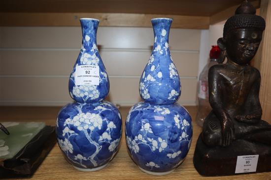 A pair of 19th century Chinese blue and white double gourd vases, Kangxi mark height 25cm